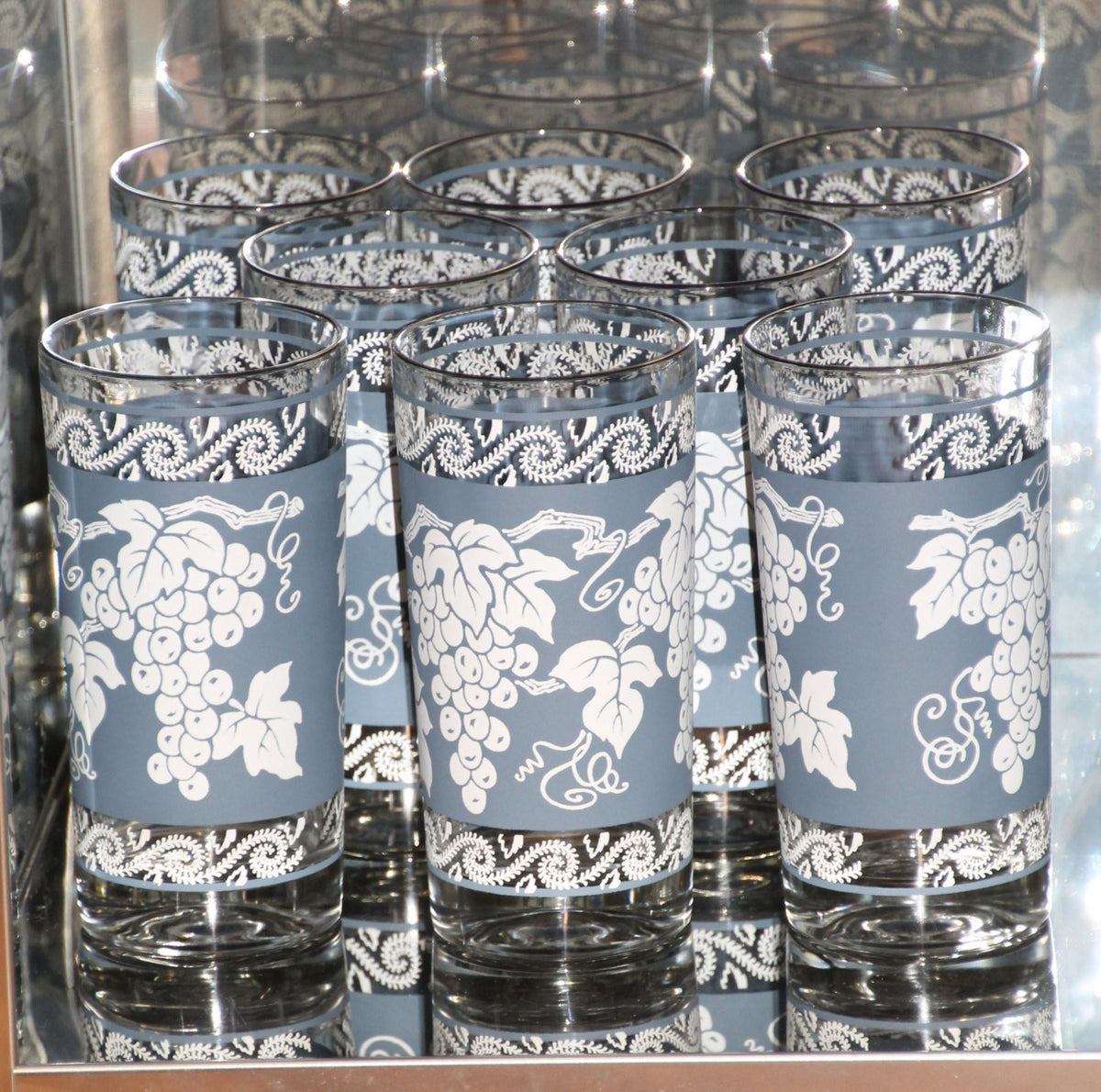 http://scotch-street-vintage.myshopify.com/cdn/shop/products/vintage-glassware-of-tall-tumbler-glasses-1960s-anchor-hocking-blue-and-white-grape-pattern-with-silver-rim-set-of-8-barware-875844_1200x1200.jpg?v=1604509046