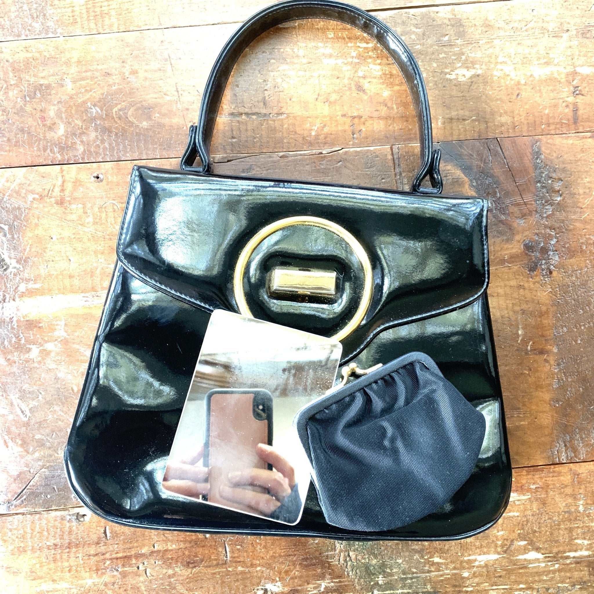 1950's/60's vintage black patent leather handbag - shot against a