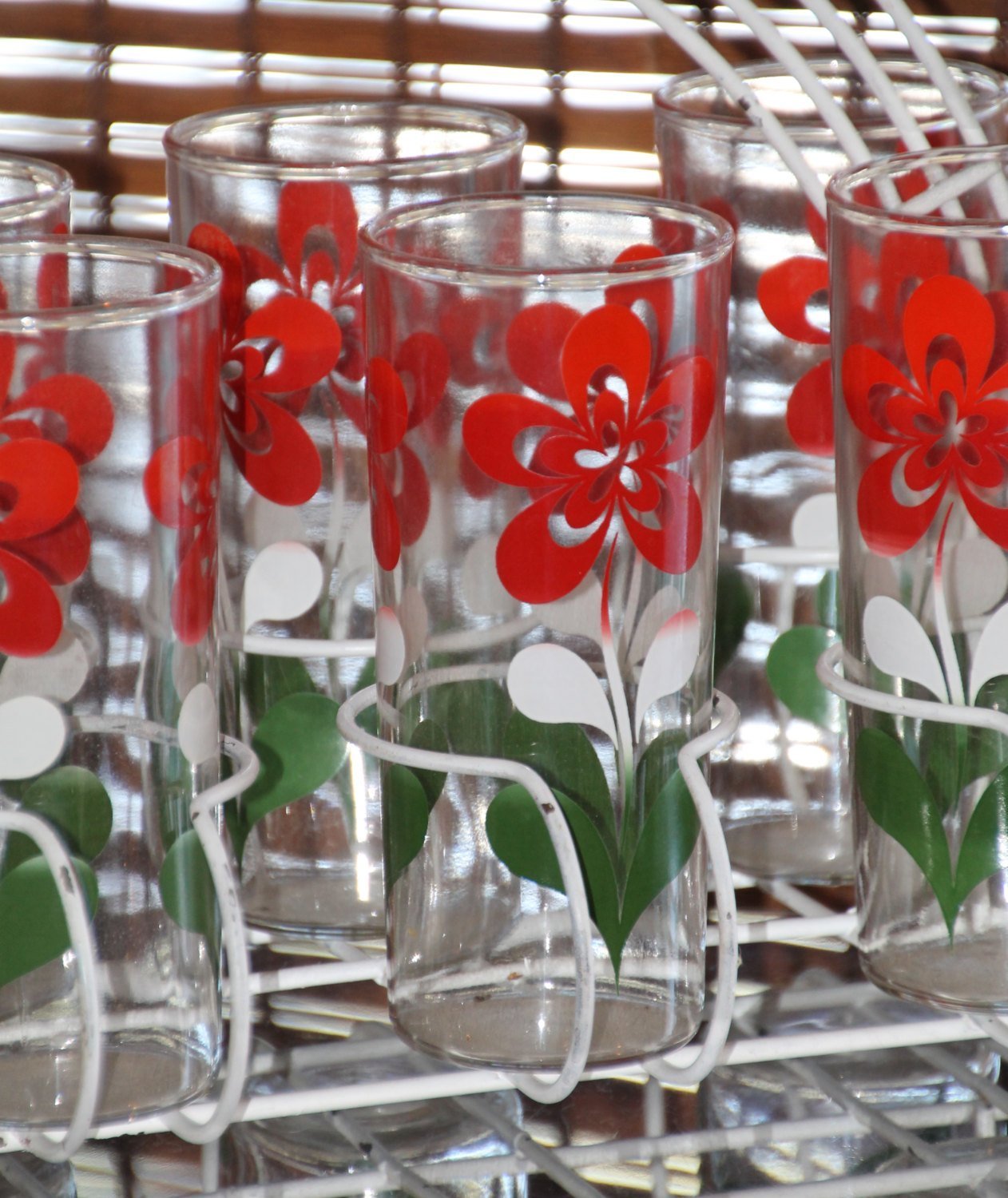 https://scotch-street-vintage.myshopify.com/cdn/shop/products/vintage-glassware-1960s-tall-tumbler-glasses-white-red-and-green-floral-design-and-white-caddy-851109.jpg?v=1604509091