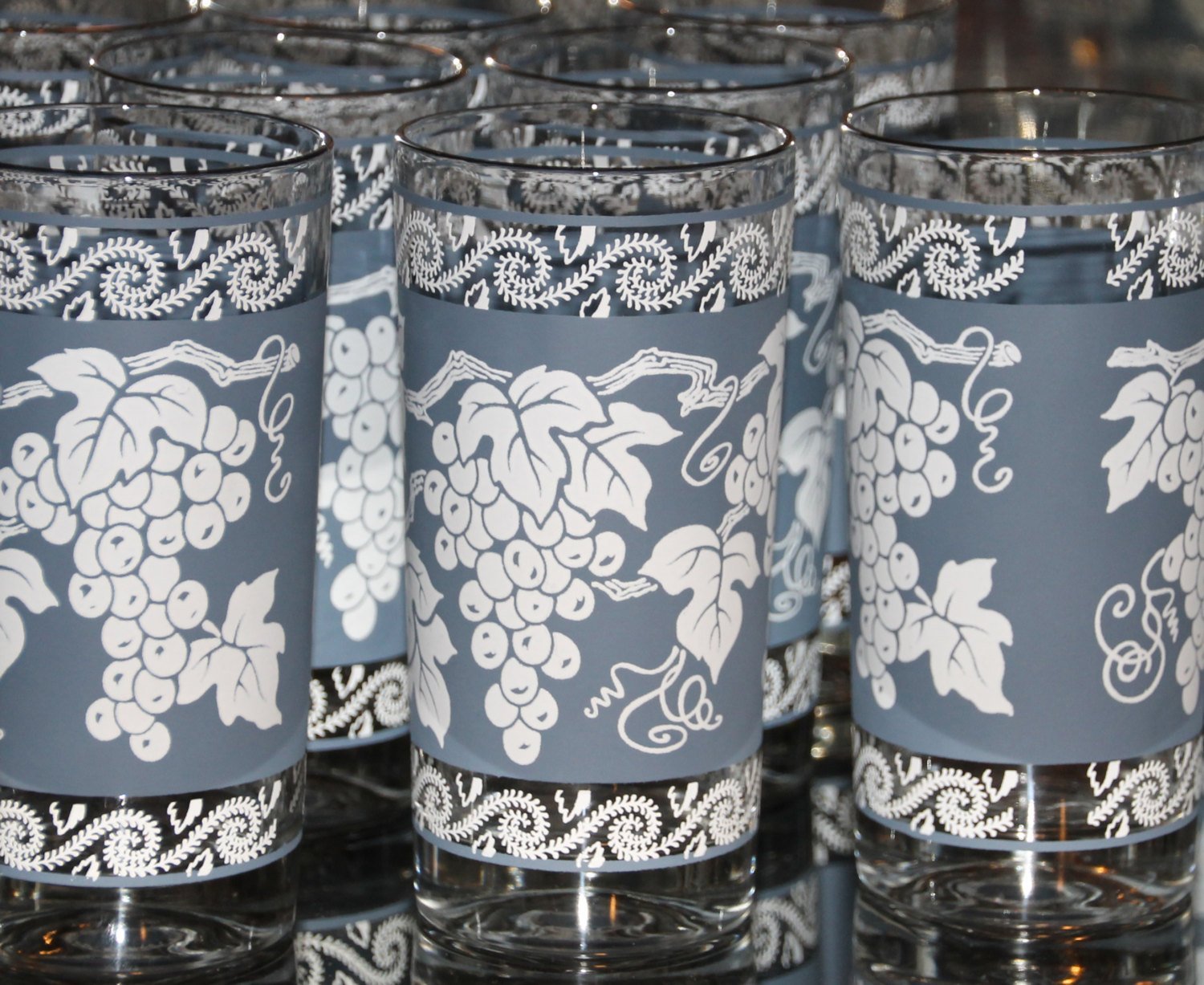 https://scotch-street-vintage.myshopify.com/cdn/shop/products/vintage-glassware-of-tall-tumbler-glasses-1960s-anchor-hocking-blue-and-white-grape-pattern-with-silver-rim-set-of-8-barware-434354.jpg?v=1604509046